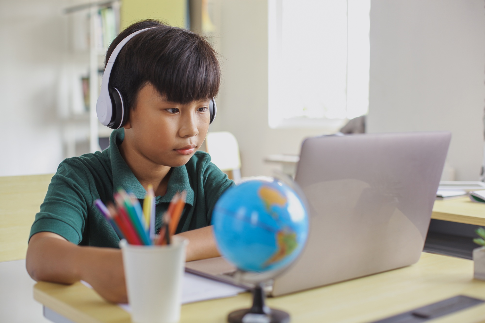 Asian student studying using a laptop